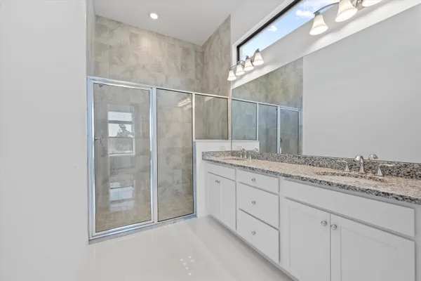 a bedroom with two beds and a window