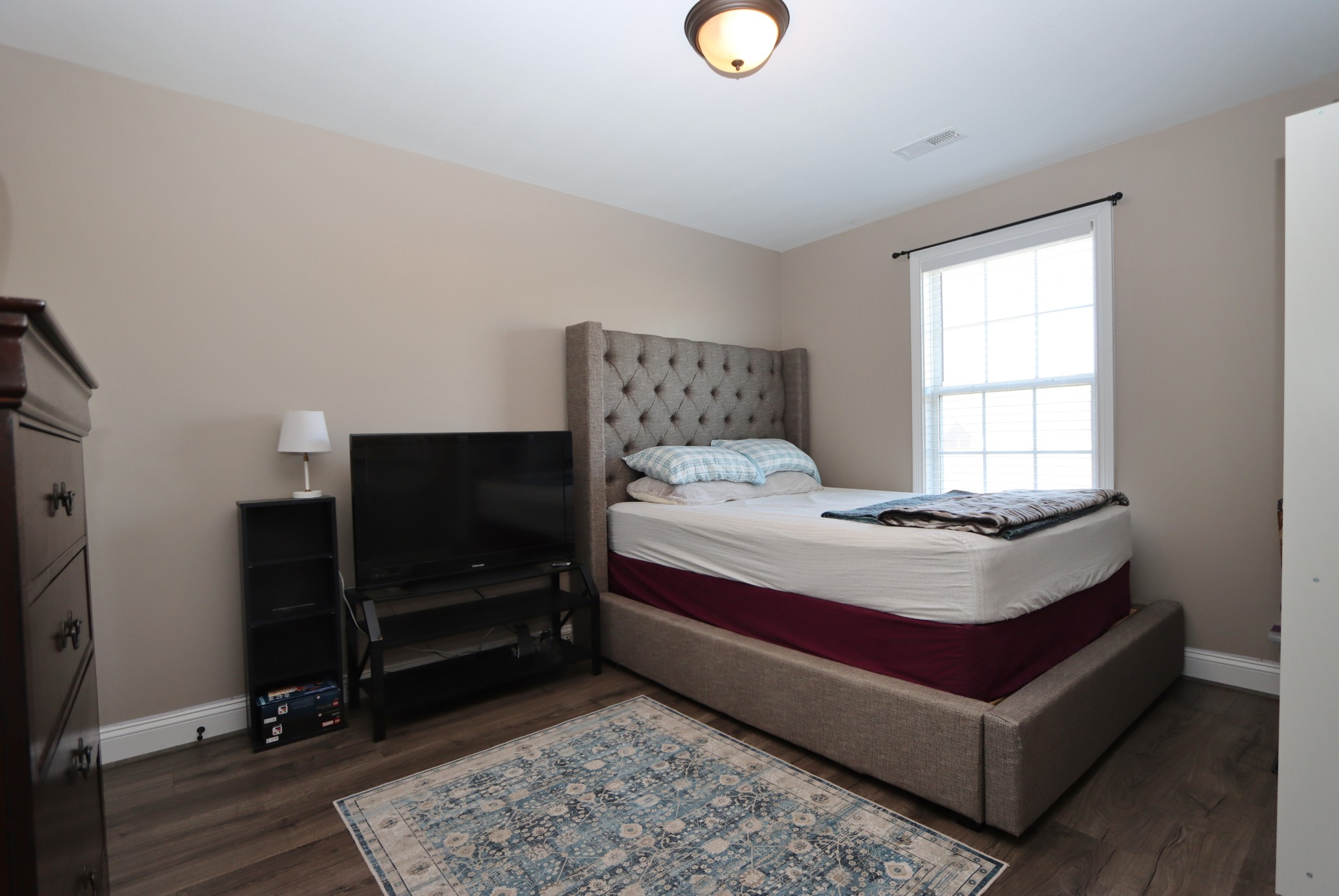 118 Ambridge Street Oak Grove, KY 42262 - Photo 12 of 14 a bedroom with a bed and a flat tv screen on dresser