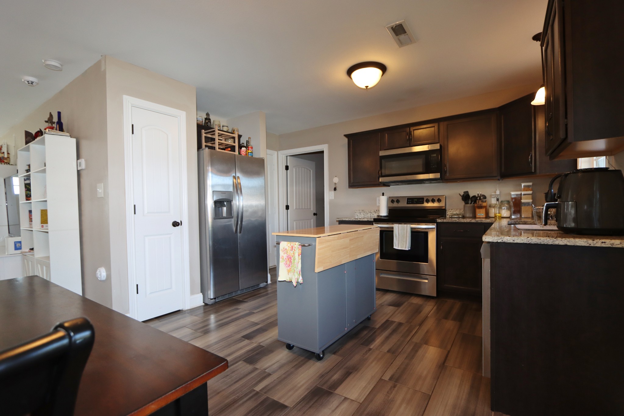 118 Ambridge Street Oak Grove, KY 42262 - Photo 6 of 14 a kitchen with stainless steel appliances granite countertop a refrigerator a sink dishwasher a stove and a microwave oven on the wooden cabinets