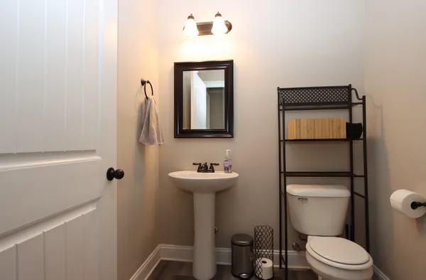 a bathroom with a toilet a sink and mirror