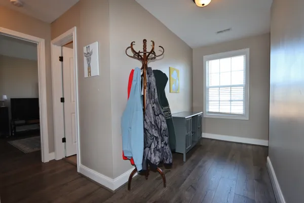 a view of a room with a window and wooden floor