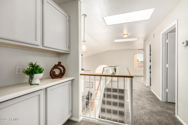 a view of hallway with microwave and potted plant