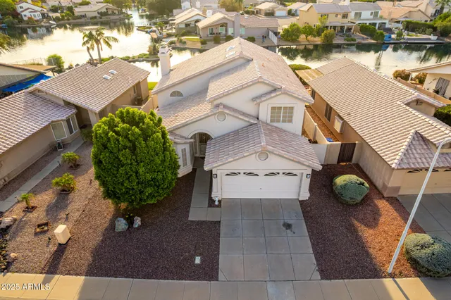 an aerial view of a house with backyard