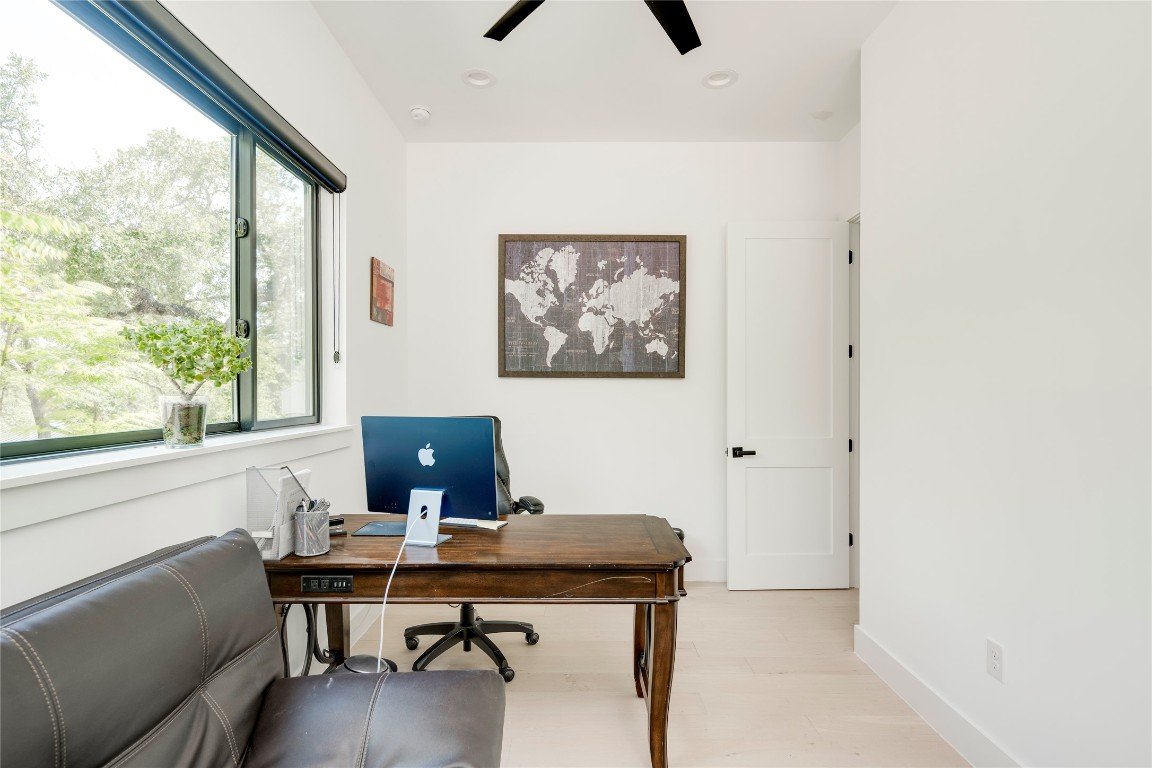 13209 Mansfield Drive Austin, TX 78732 - Photo 18 of 27 a view of a workspace with furniture and a window