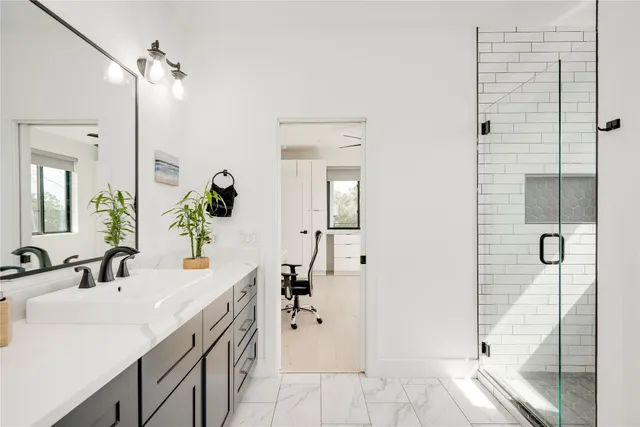 a bathroom with a sink a toilet and shower