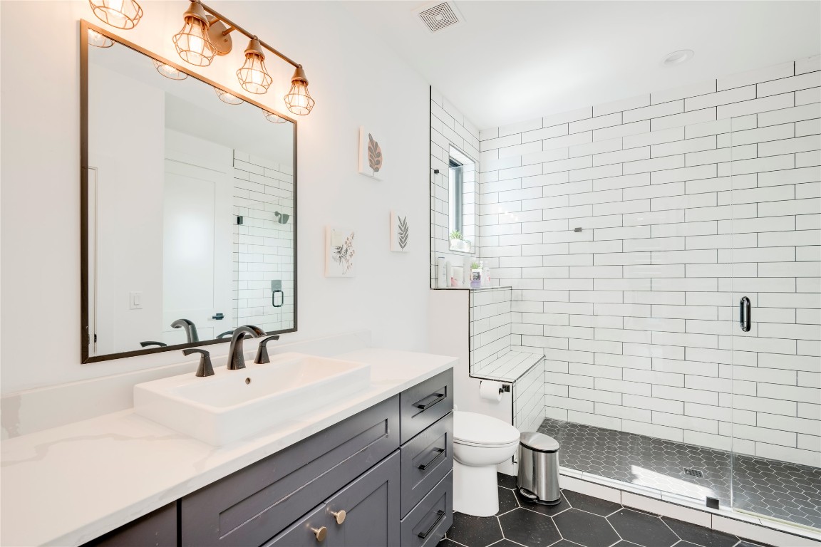 13209 Mansfield Drive Austin, TX 78732 - Photo 20 of 27 a bathroom with a sink a toilet and shower