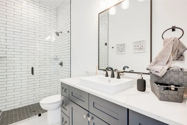 a utility room with fridge dryer and washer