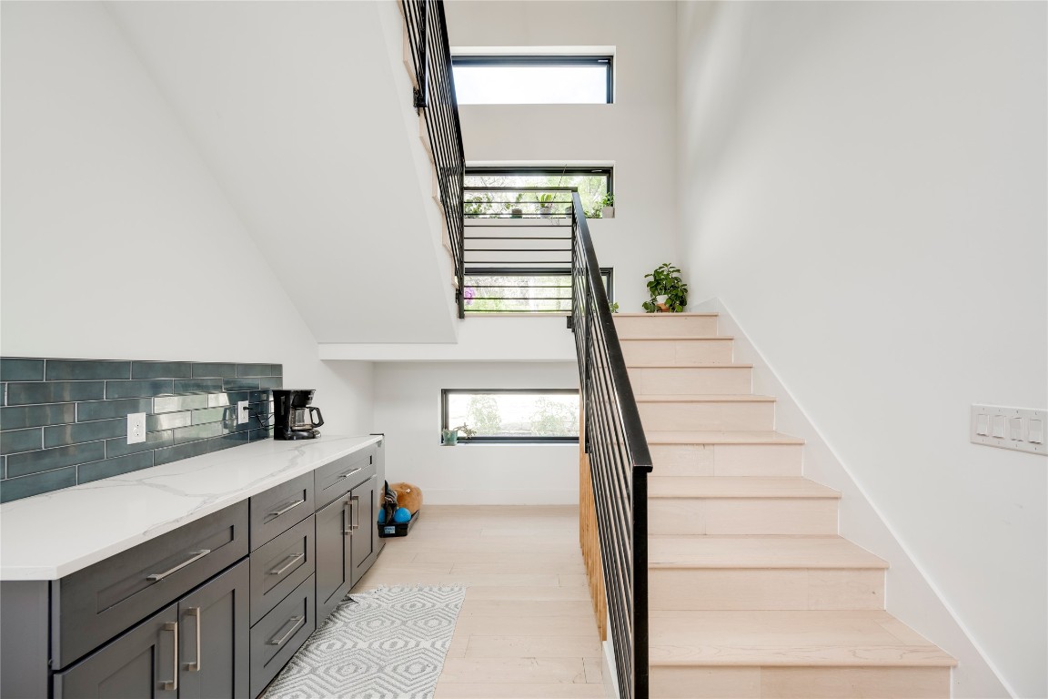 13209 Mansfield Drive Austin, TX 78732 - Photo 22 of 27 Staircase featuring a towering ceiling and wood finished floors
