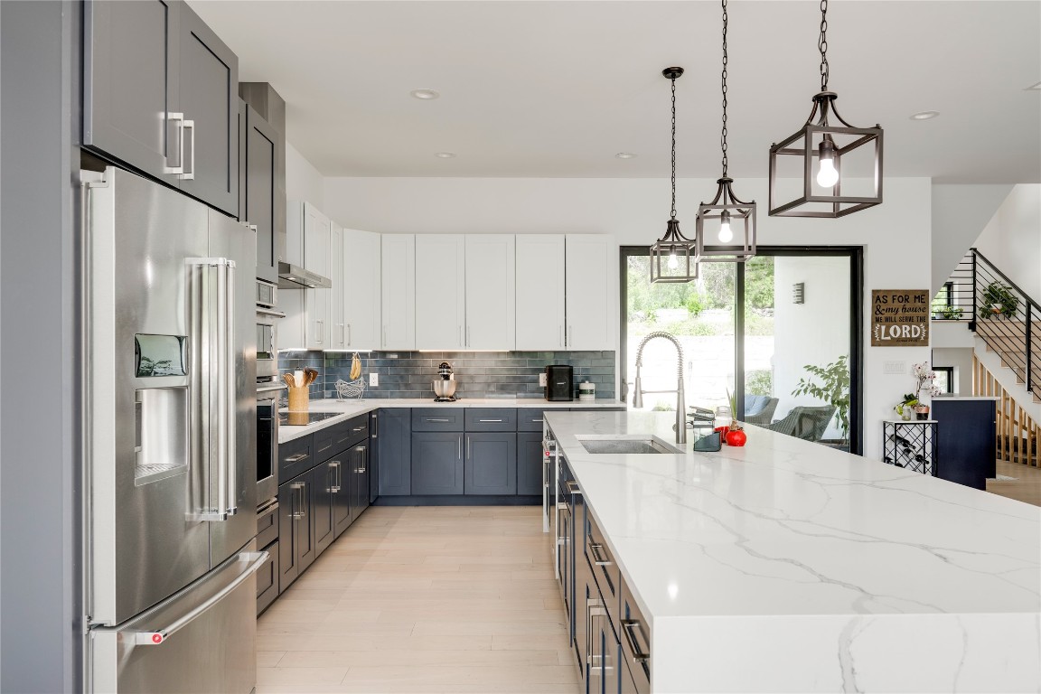 13209 Mansfield Drive Austin, TX 78732 - Photo 5 of 27 a kitchen with refrigerator cabinets and furniture