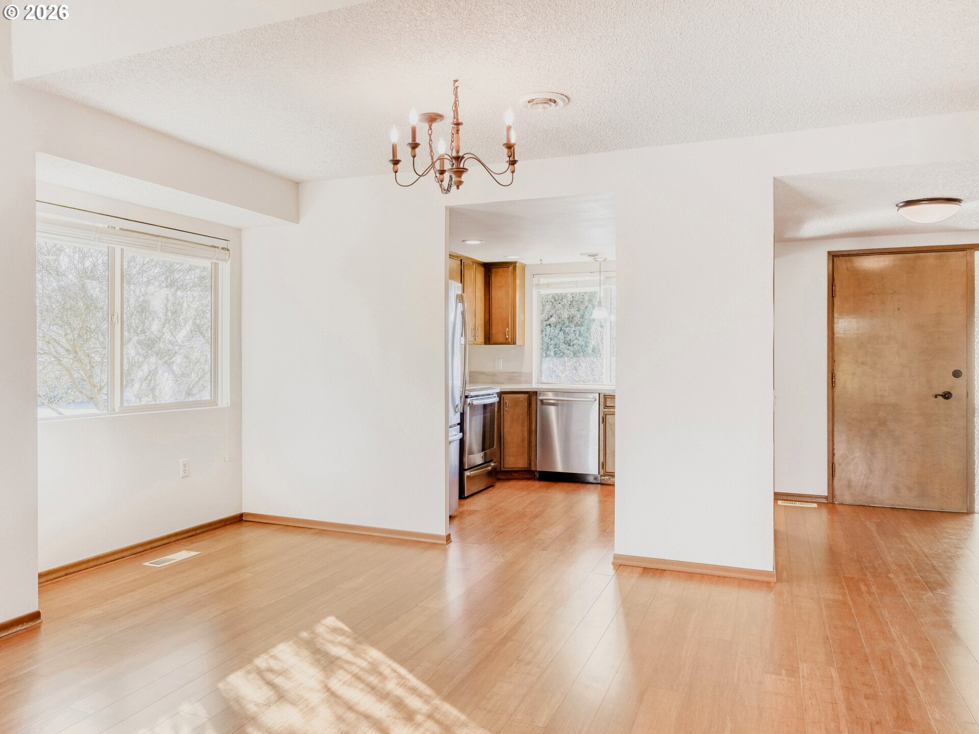 16588 Southwest Matador Lane Portland, OR 97224 - Photo 11 of 28 a view of an empty room with wooden floor and a window