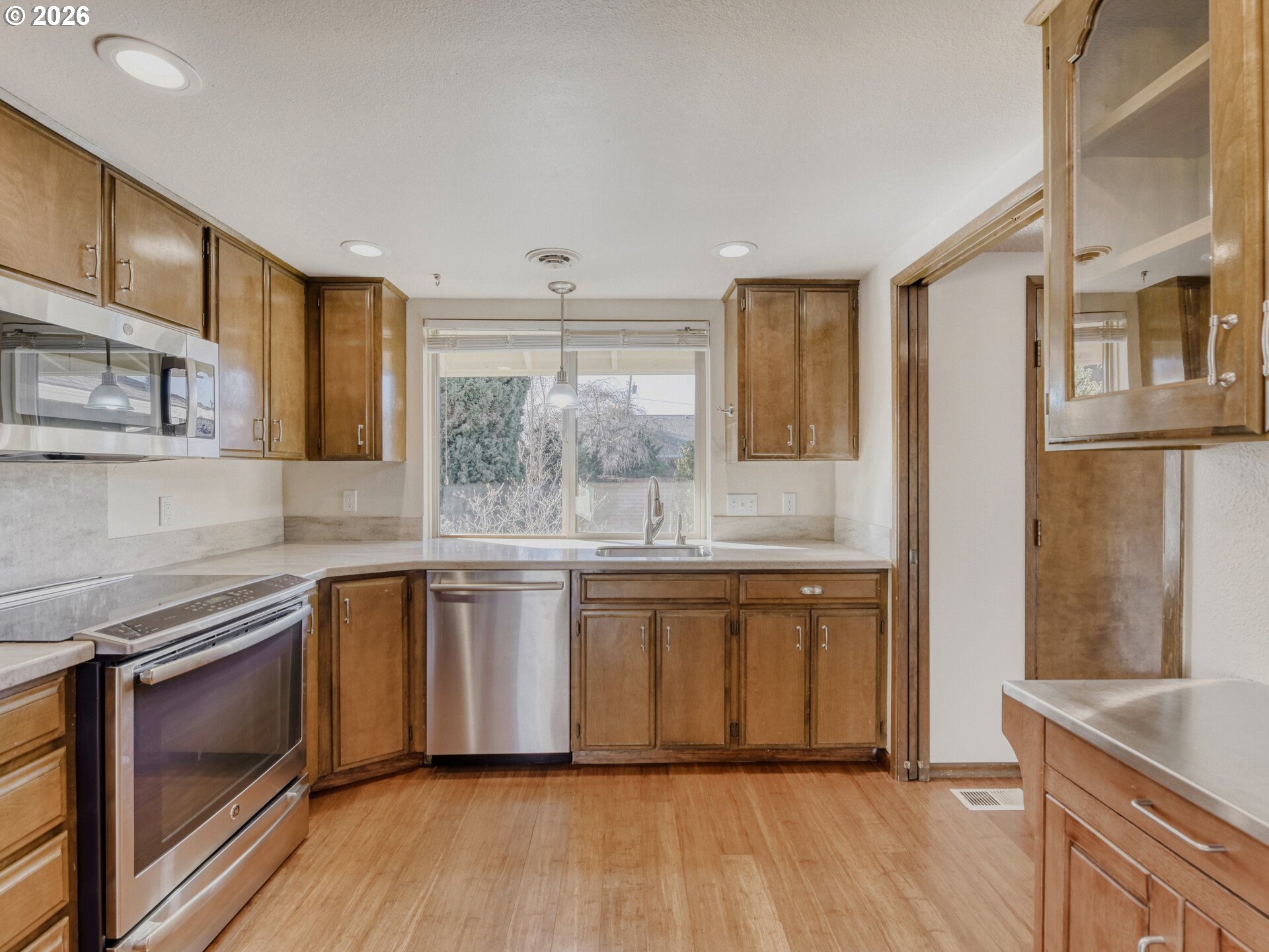 16588 Southwest Matador Lane Portland, OR 97224 - Photo 12 of 28 a large kitchen with stainless steel appliances granite countertop a stove and a sink