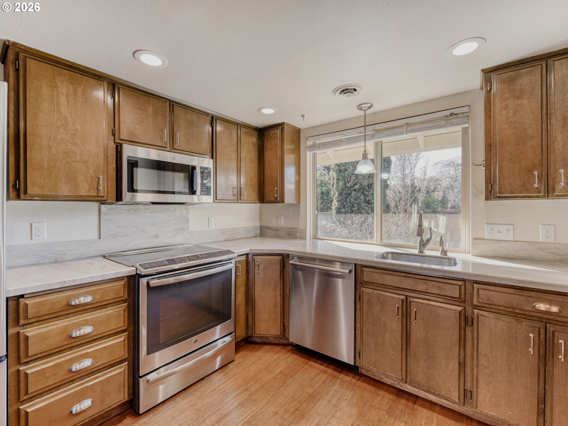 16588 Southwest Matador Lane Portland, OR 97224 - Photo 13 of 28 a kitchen with a sink stove and microwave