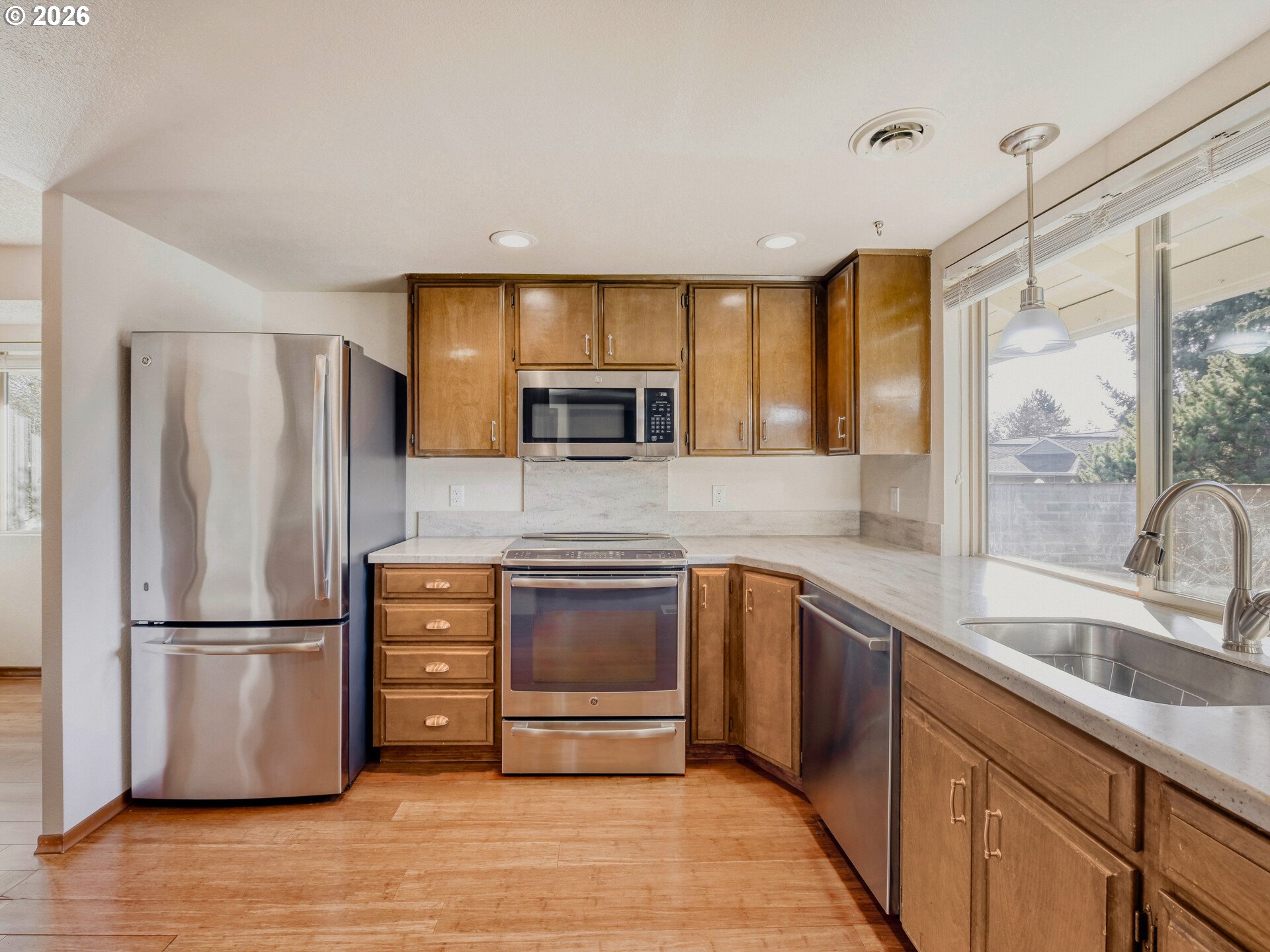 16588 Southwest Matador Lane Portland, OR 97224 - Photo 15 of 28 a kitchen with granite countertop a refrigerator and a sink