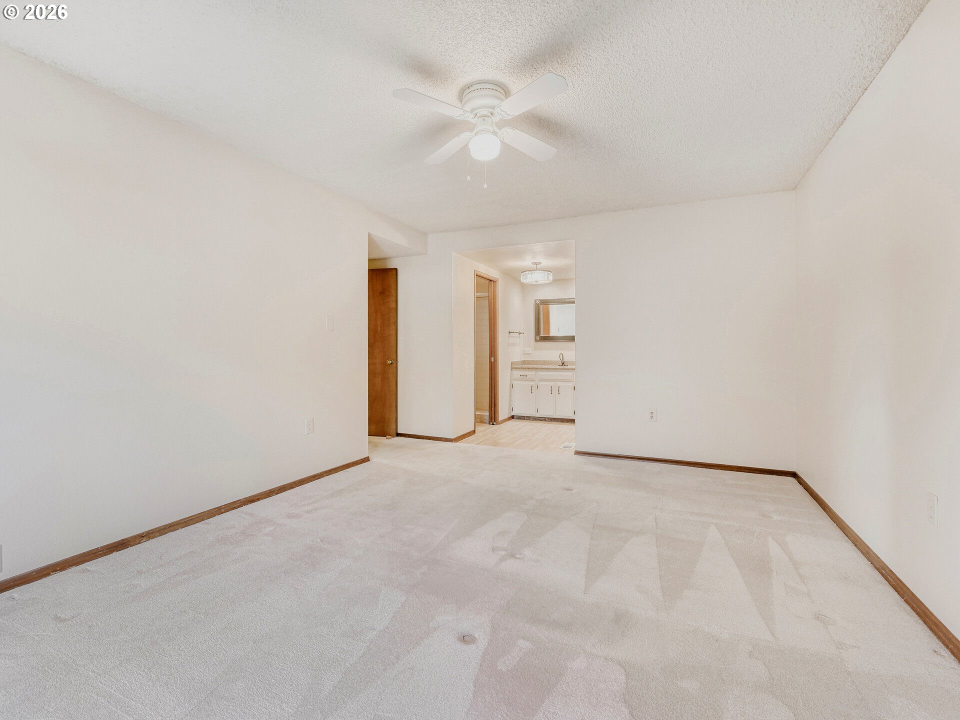 16588 Southwest Matador Lane Portland, OR 97224 - Photo 18 of 28 an empty room with a ceiling fan and carpet