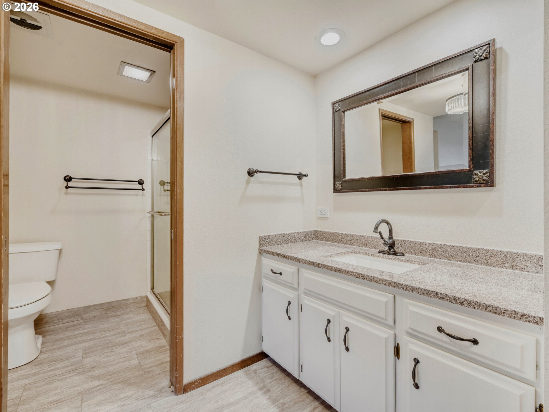 16588 Southwest Matador Lane Portland, OR 97224 - Photo 21 of 28 a bathroom with a granite countertop sink vanity mirror and toilet