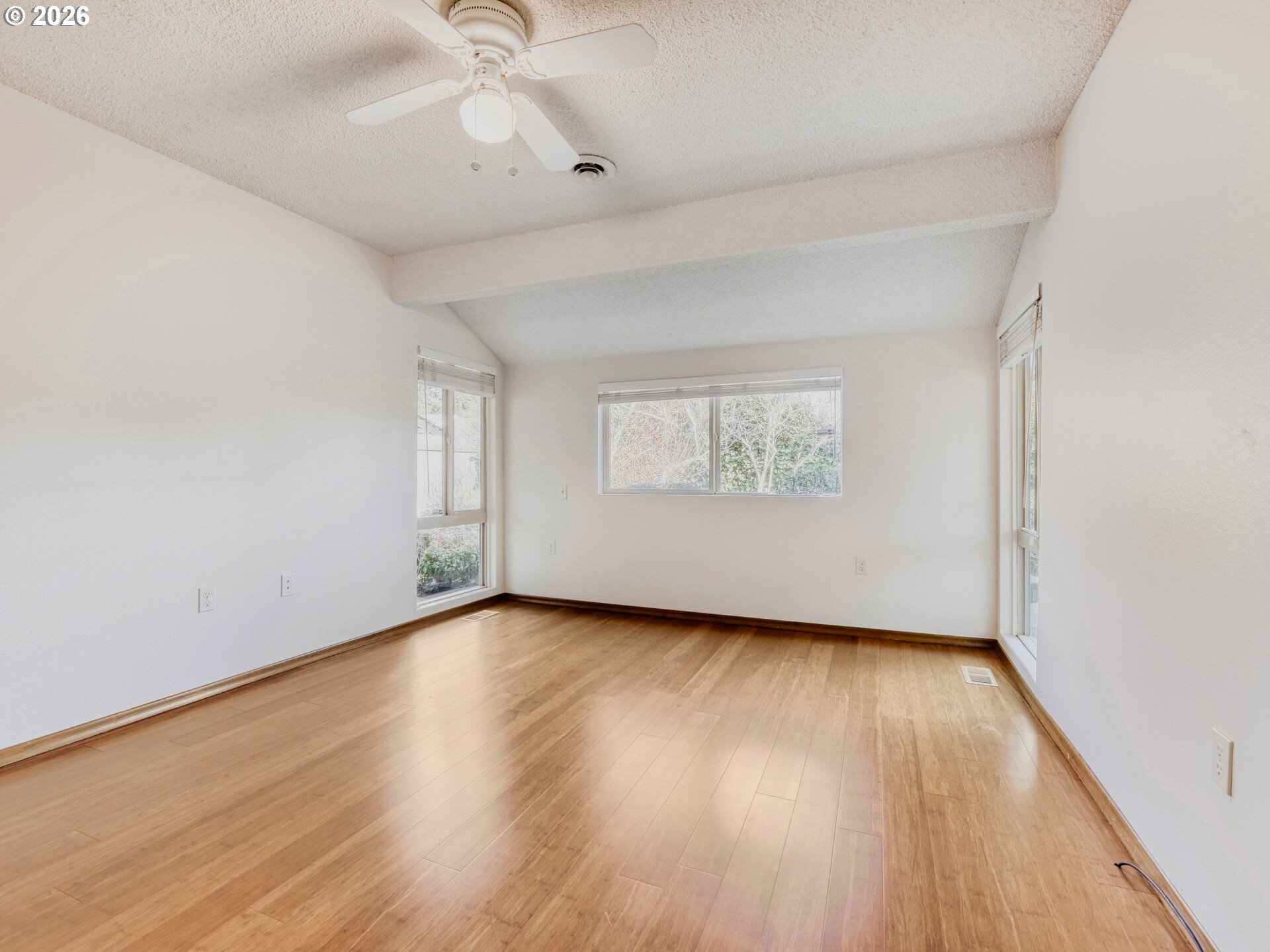 16588 Southwest Matador Lane Portland, OR 97224 - Photo 23 of 28 an empty room with wooden floor chandelier fan and windows