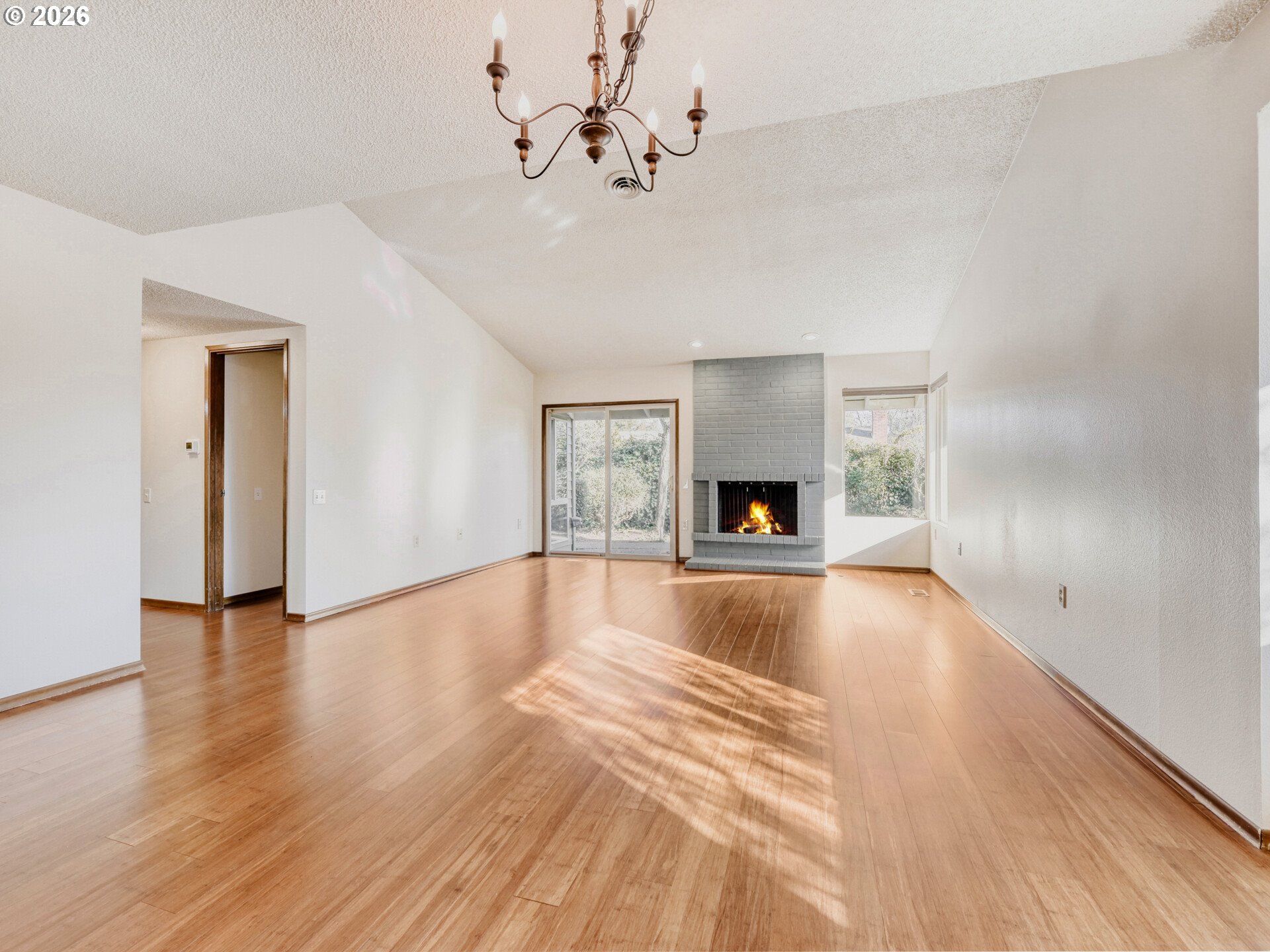 16588 Southwest Matador Lane Portland, OR 97224 - Photo 7 of 28 a view of an empty room with a fireplace and wooden floor