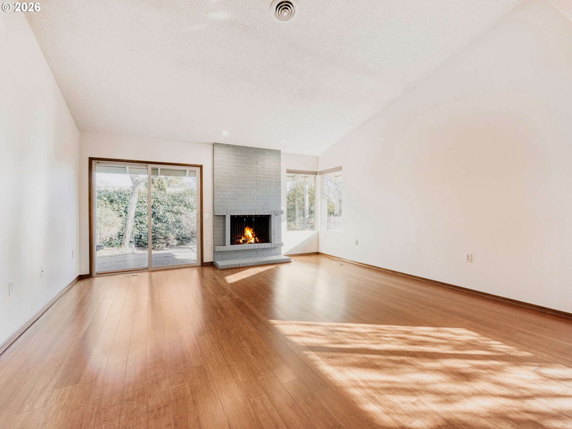 16588 Southwest Matador Lane Portland, OR 97224 - Photo 8 of 28 a view of empty room with wooden floor and fireplace