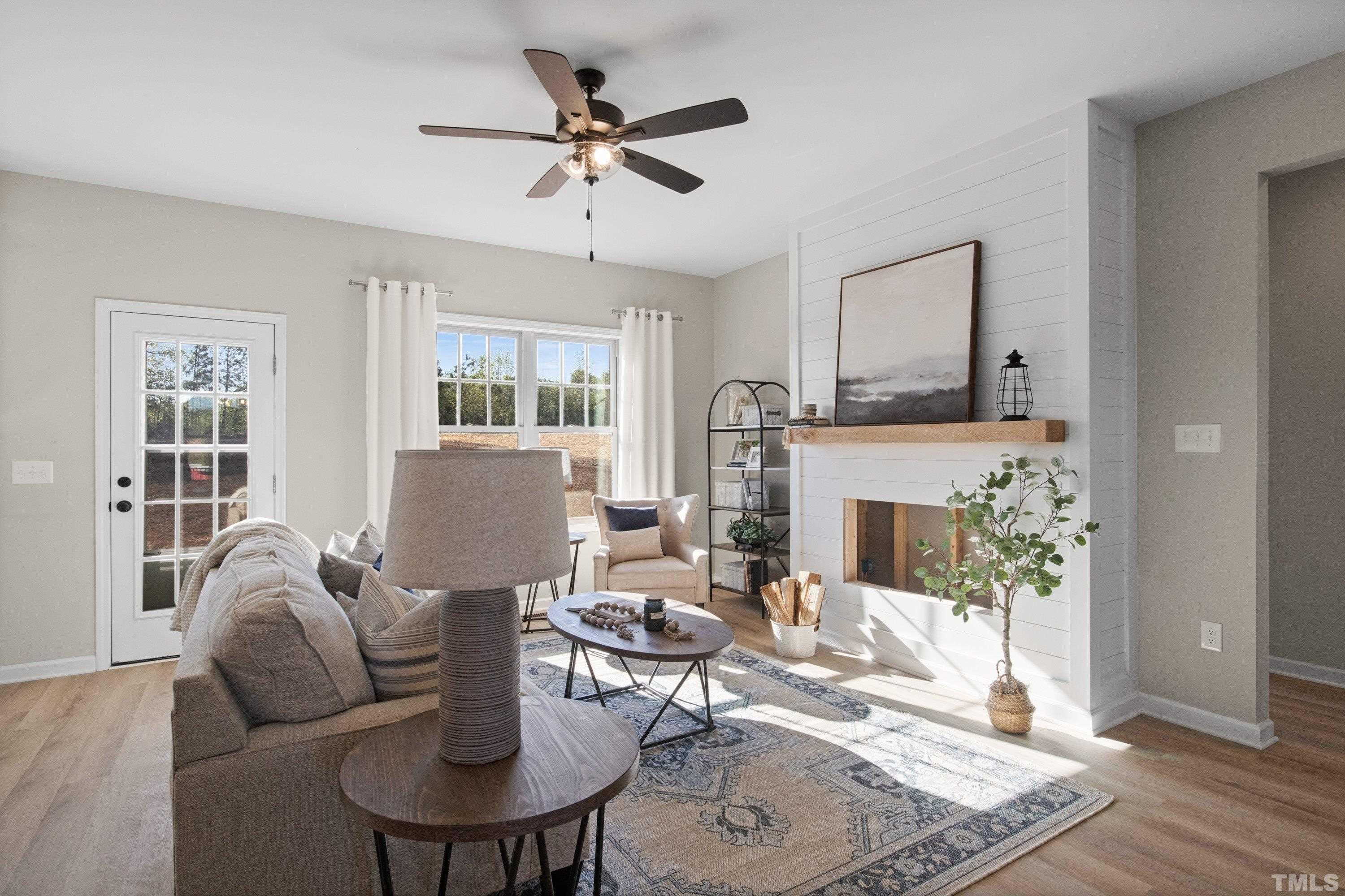 9765 Bear Run Lane Middlesex, NC 27557 - Photo 12 of 38 a living room with furniture a fireplace and a chandelier