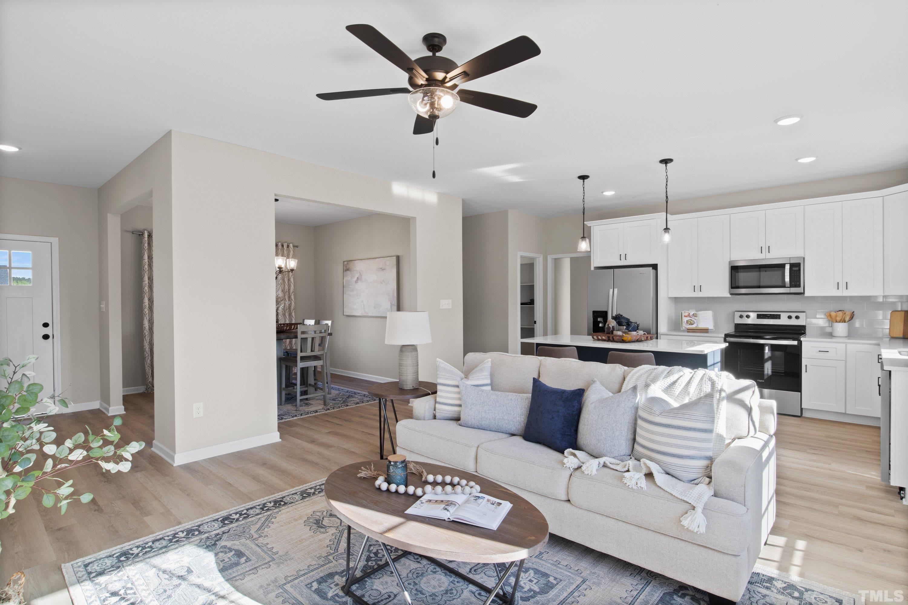 9765 Bear Run Lane Middlesex, NC 27557 - Photo 14 of 38 a living room with furniture kitchen view and a wooden floor