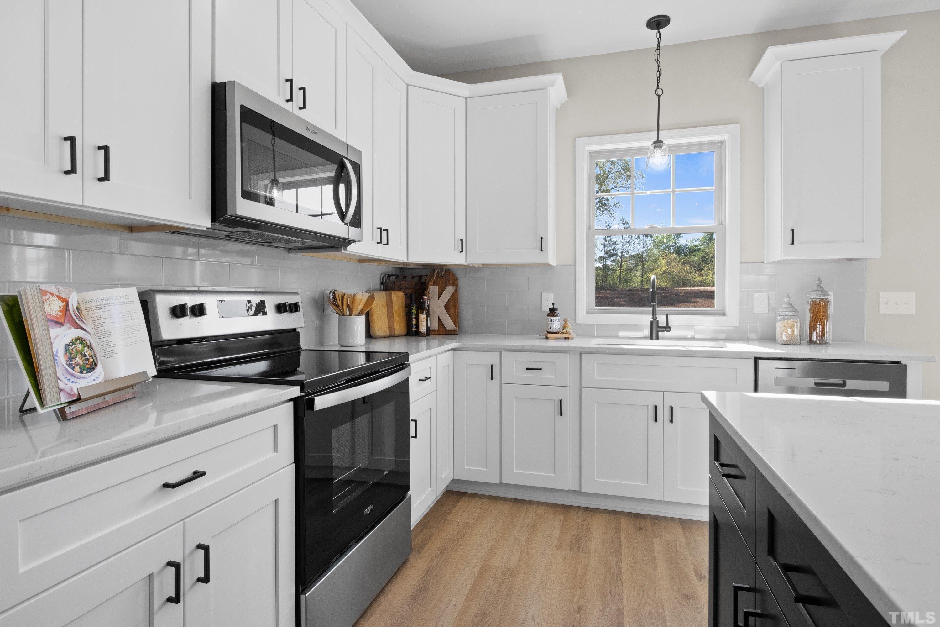 9765 Bear Run Lane Middlesex, NC 27557 - Photo 24 of 38 a kitchen with cabinets appliances and a window