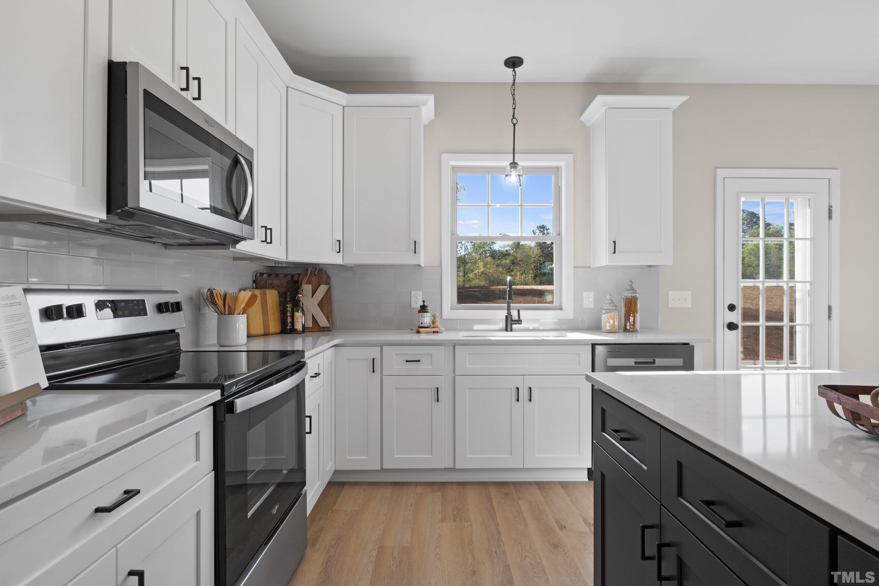 9765 Bear Run Lane Middlesex, NC 27557 - Photo 25 of 38 a kitchen with a sink stove and microwave