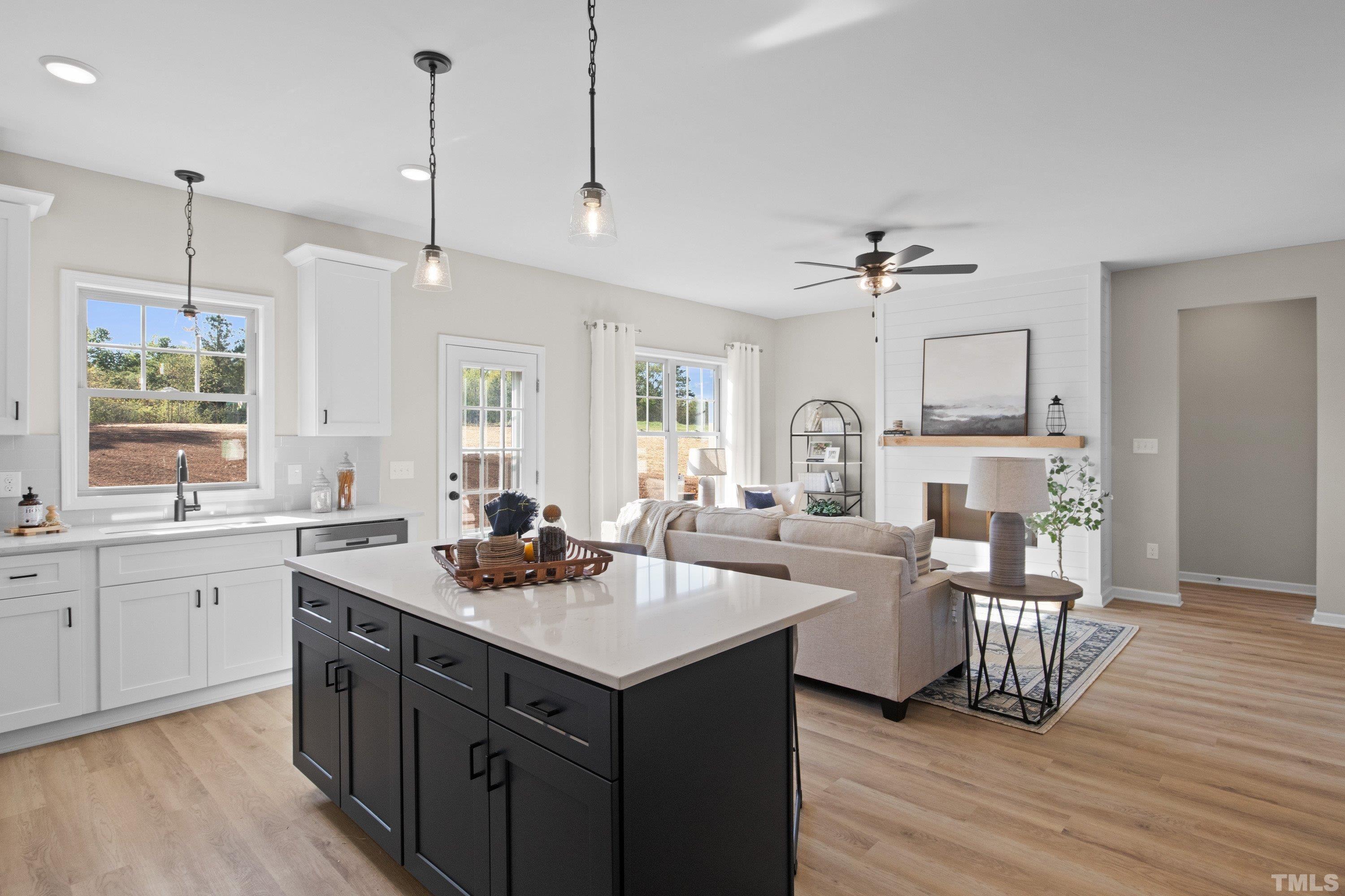 9765 Bear Run Lane Middlesex, NC 27557 - Photo 26 of 38 a kitchen with a sink stove and wooden floor