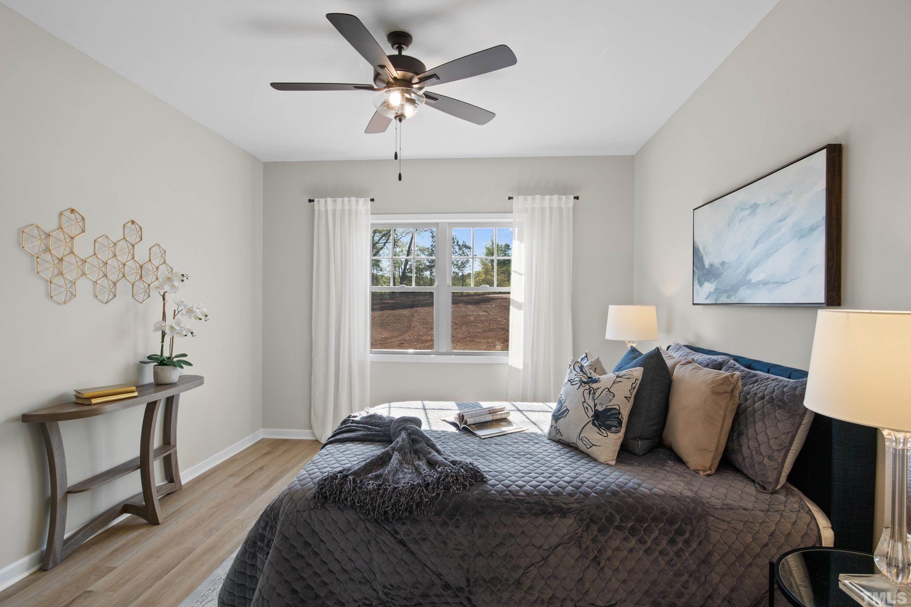 9765 Bear Run Lane Middlesex, NC 27557 - Photo 27 of 38 a bedroom with a large bed and a window