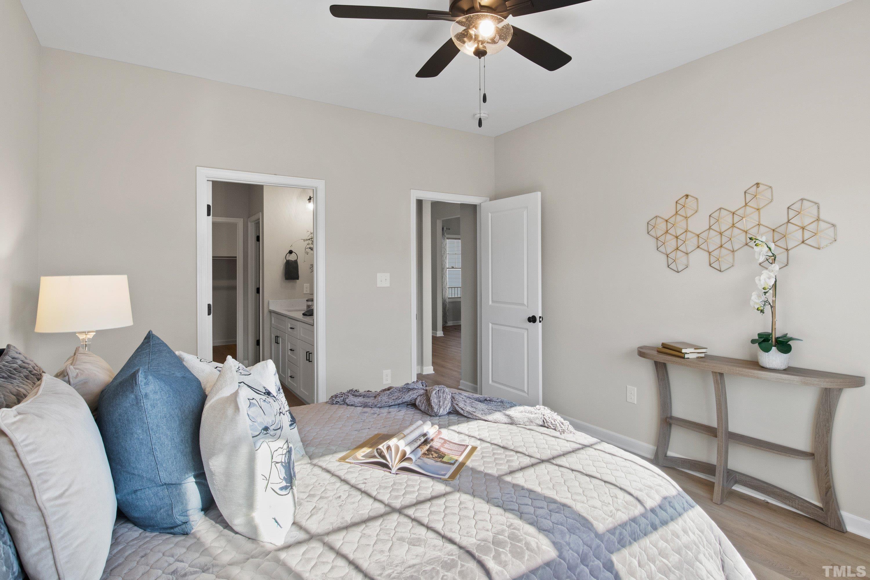 9765 Bear Run Lane Middlesex, NC 27557 - Photo 28 of 38 a bedroom with a bed and a chandelier
