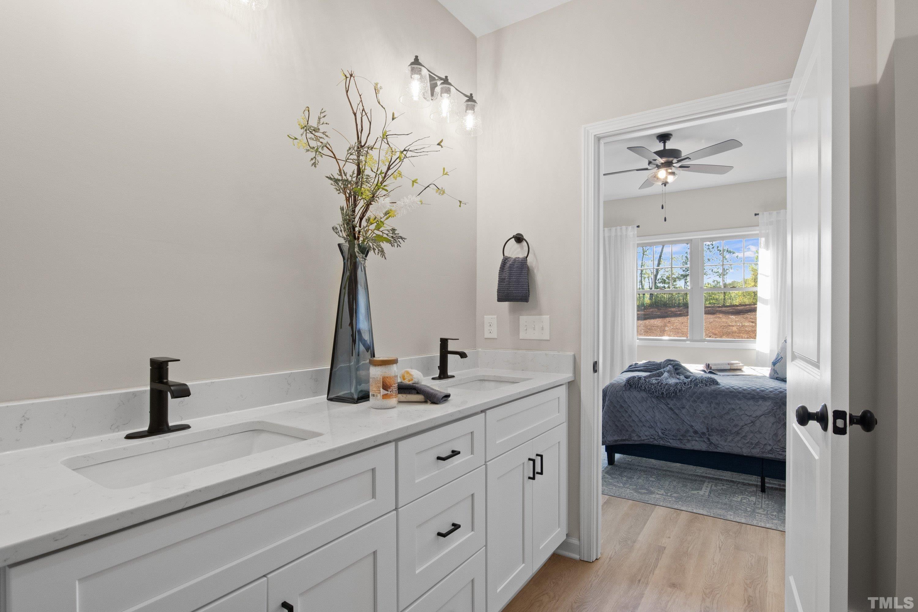 9765 Bear Run Lane Middlesex, NC 27557 - Photo 30 of 38 a en suite bathroom with a double vanity sink and a mirror