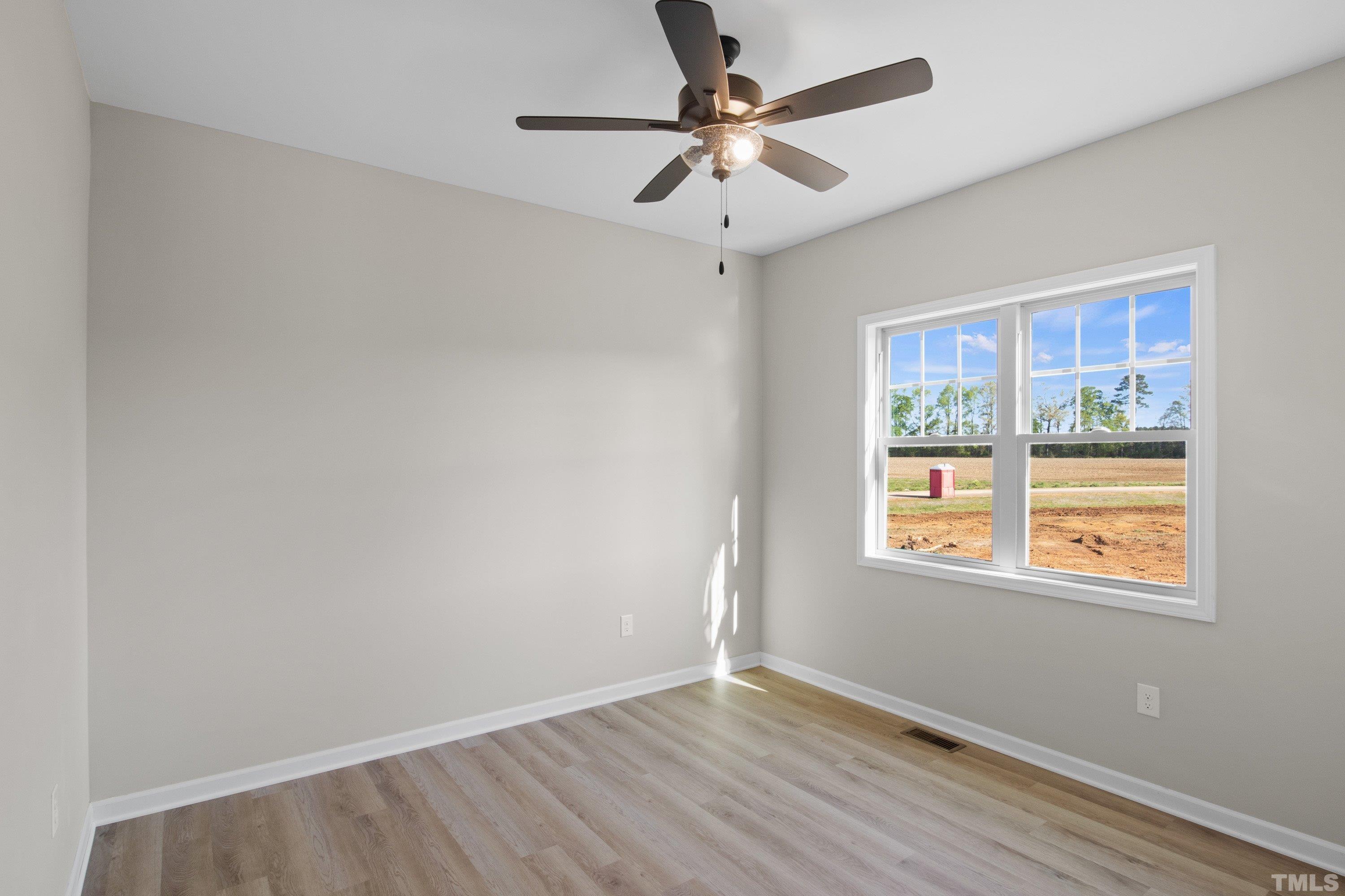 9765 Bear Run Lane Middlesex, NC 27557 - Photo 34 of 38 an empty room with a window and a fan