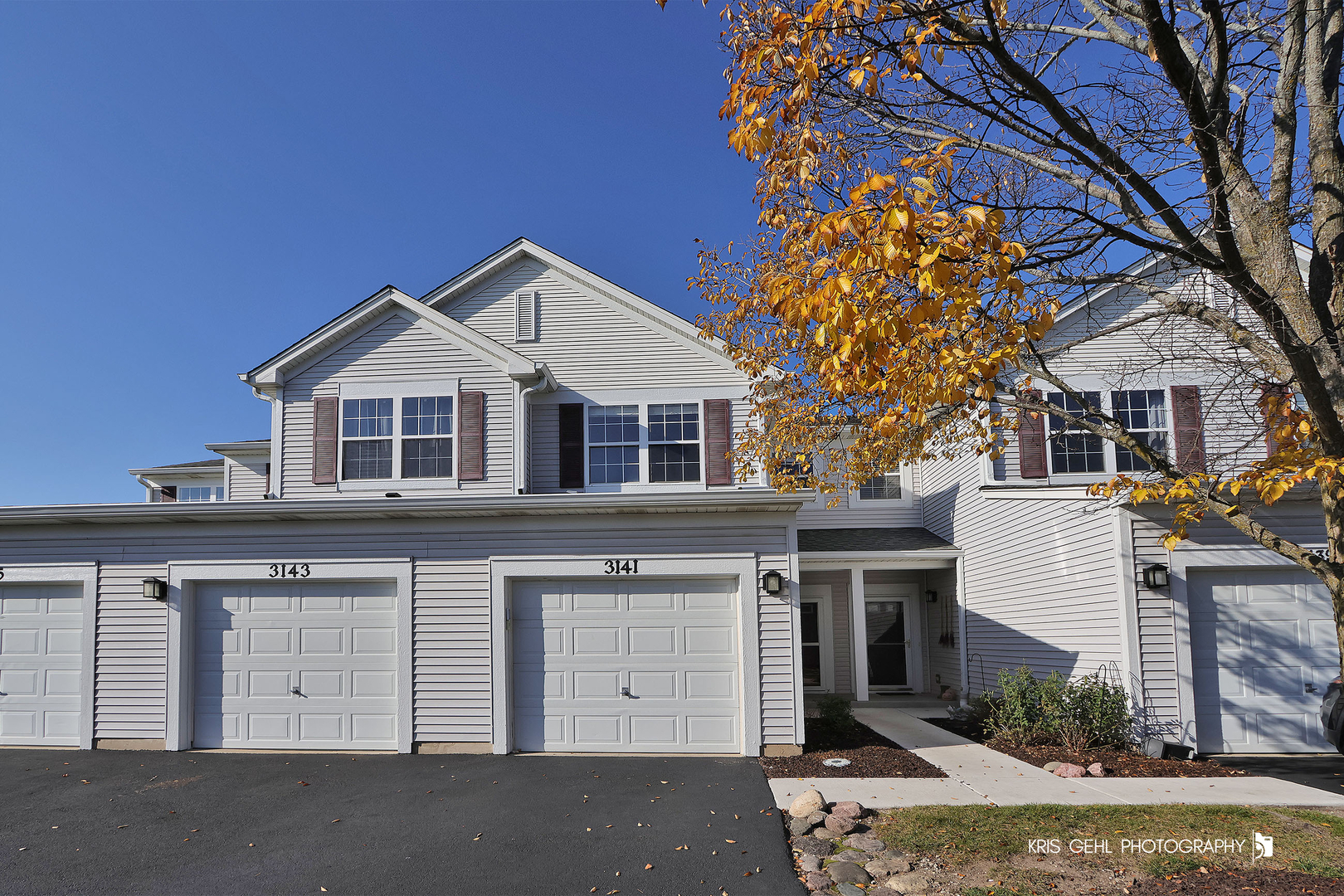 3141 Falling Waters Lane, Unit 3141 Lindenhurst, IL 60046 - Photo 1 of 17 a front view of a house with a yard and garage