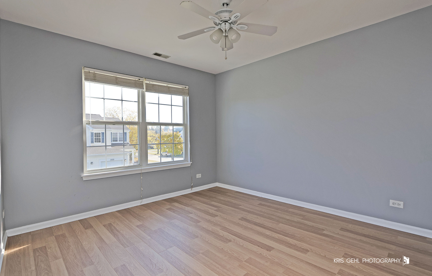 3141 Falling Waters Lane, Unit 3141 Lindenhurst, IL 60046 - Photo 11 of 17 a view of an empty room with wooden floor and a window