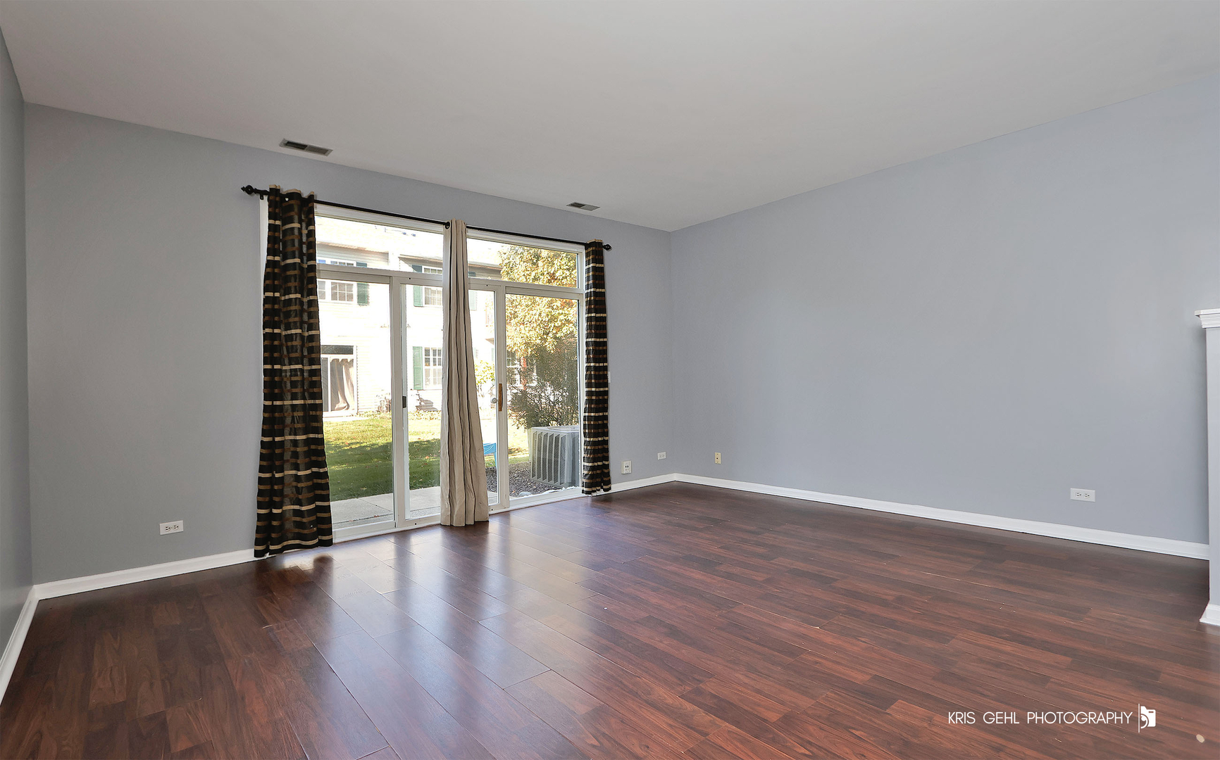 3141 Falling Waters Lane, Unit 3141 Lindenhurst, IL 60046 - Photo 3 of 17 a view of an empty room with wooden floor and a window