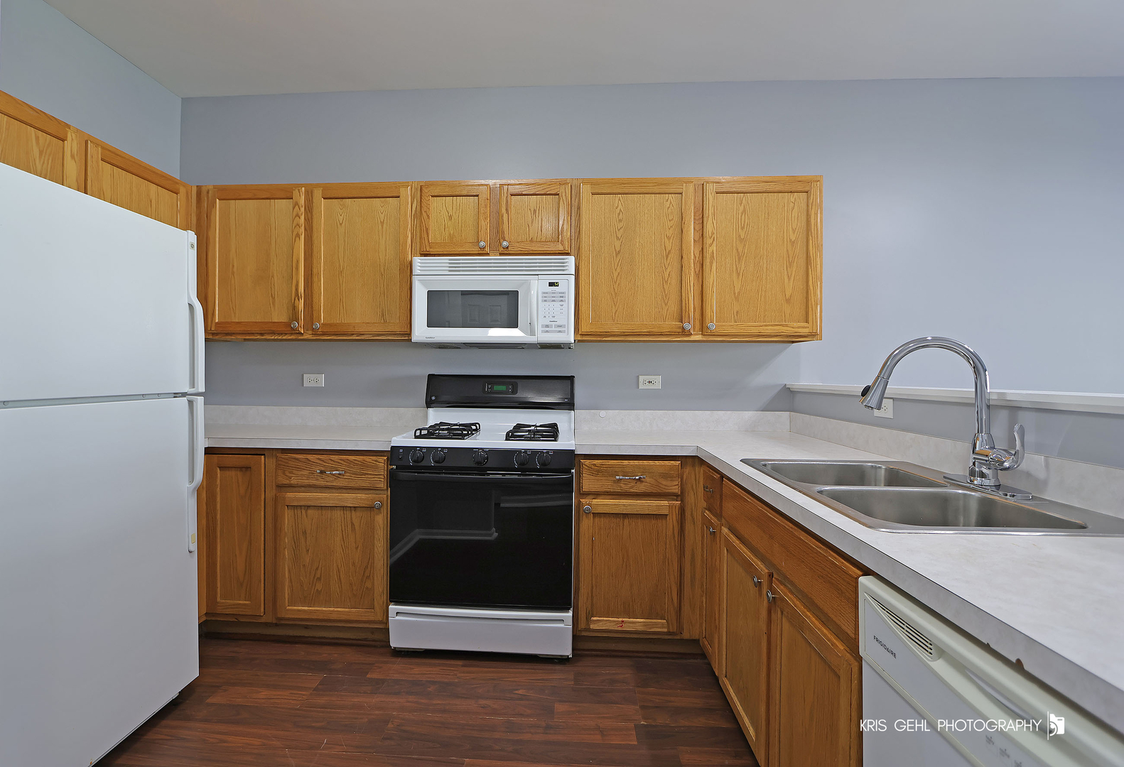 3141 Falling Waters Lane, Unit 3141 Lindenhurst, IL 60046 - Photo 5 of 17 a kitchen with stainless steel appliances granite countertop a sink stove and refrigerator