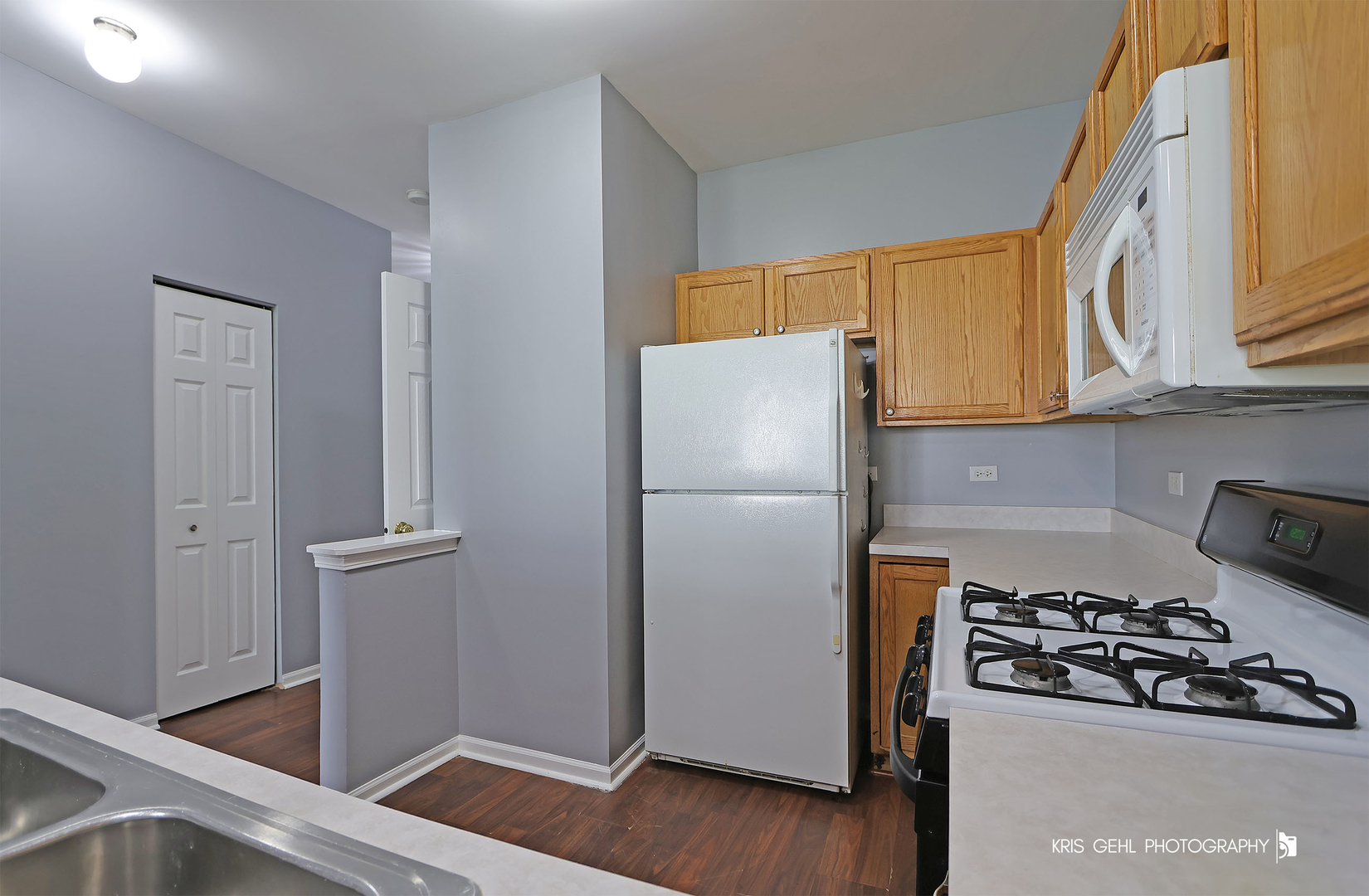 3141 Falling Waters Lane, Unit 3141 Lindenhurst, IL 60046 - Photo 6 of 17 a kitchen with stainless steel appliances granite countertop a refrigerator and a stove top oven