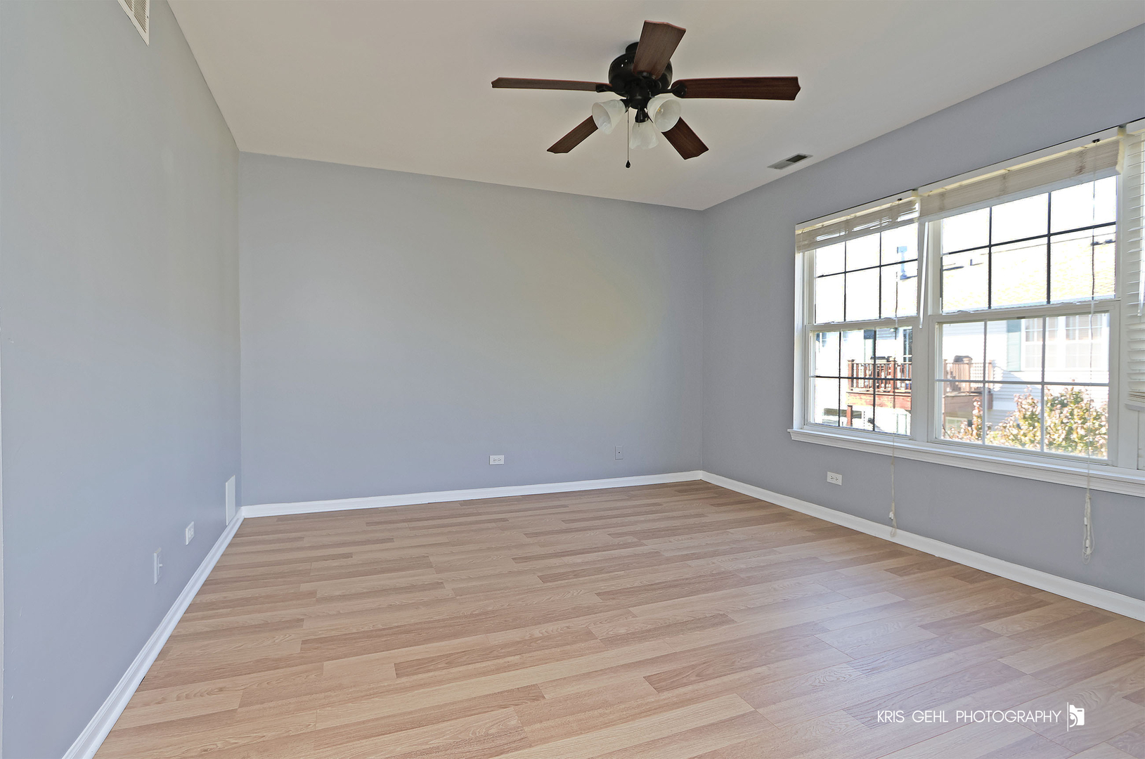 3141 Falling Waters Lane, Unit 3141 Lindenhurst, IL 60046 - Photo 9 of 17 wooden floor in an empty room with a window