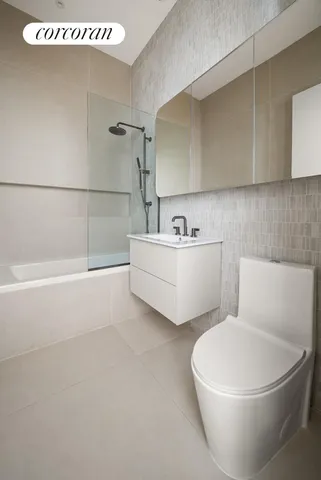 a bathroom with a sink mirror and toilet