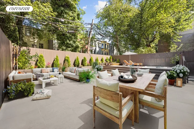 a side view of a house with flower garden