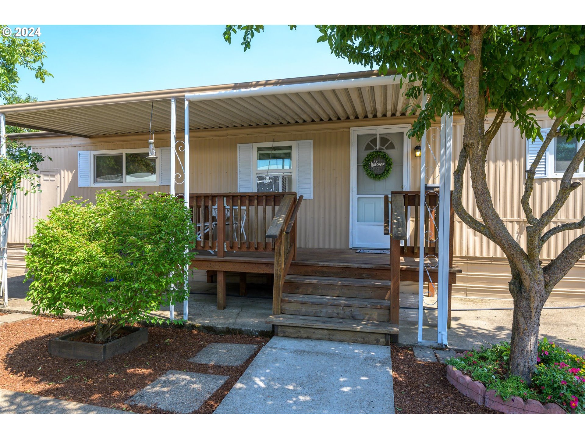 2150 Laura Street, Unit 90 Springfield, OR 97477 - Photo 2 of 18 a front view of house with yard and green space