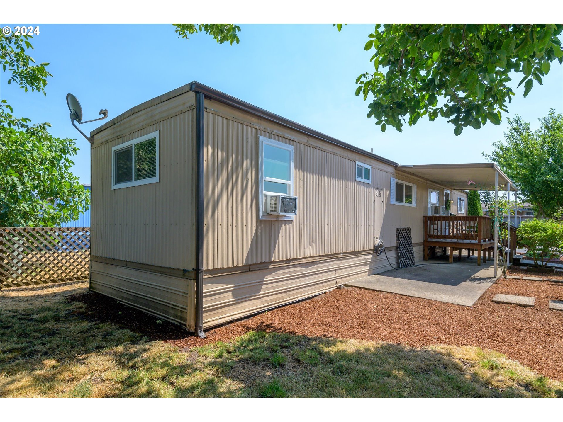 2150 Laura Street, Unit 90 Springfield, OR 97477 - Photo 4 of 18 a view of a house with backyard and sitting area