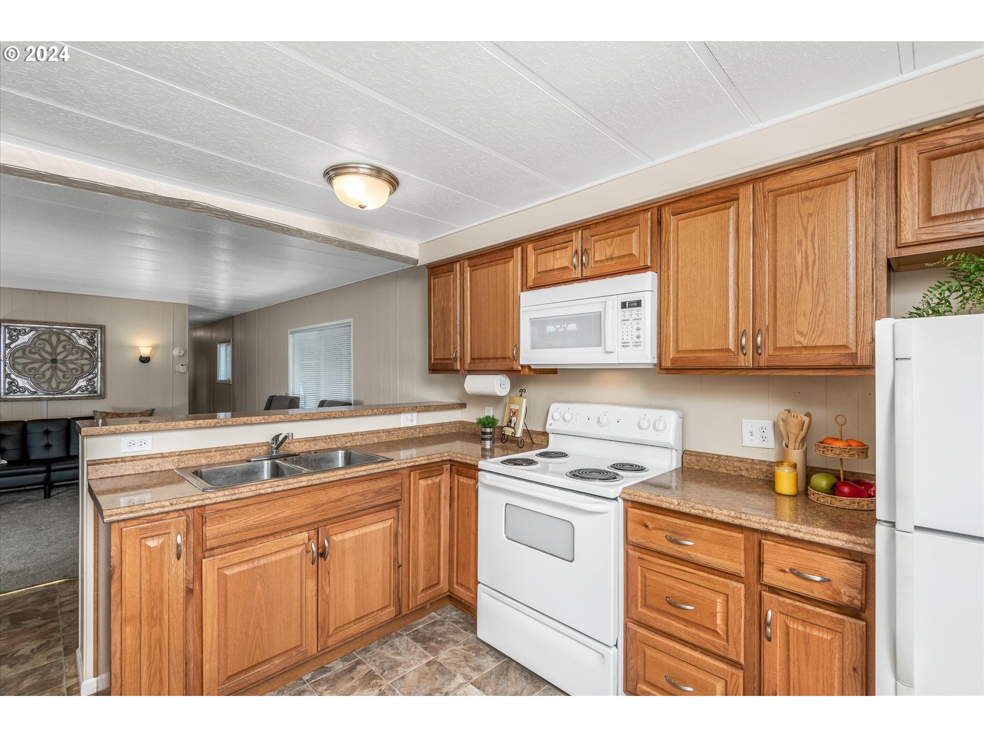 2150 Laura Street, Unit 90 Springfield, OR 97477 - Photo 6 of 18 a kitchen with cabinets appliances a sink and a counter top space