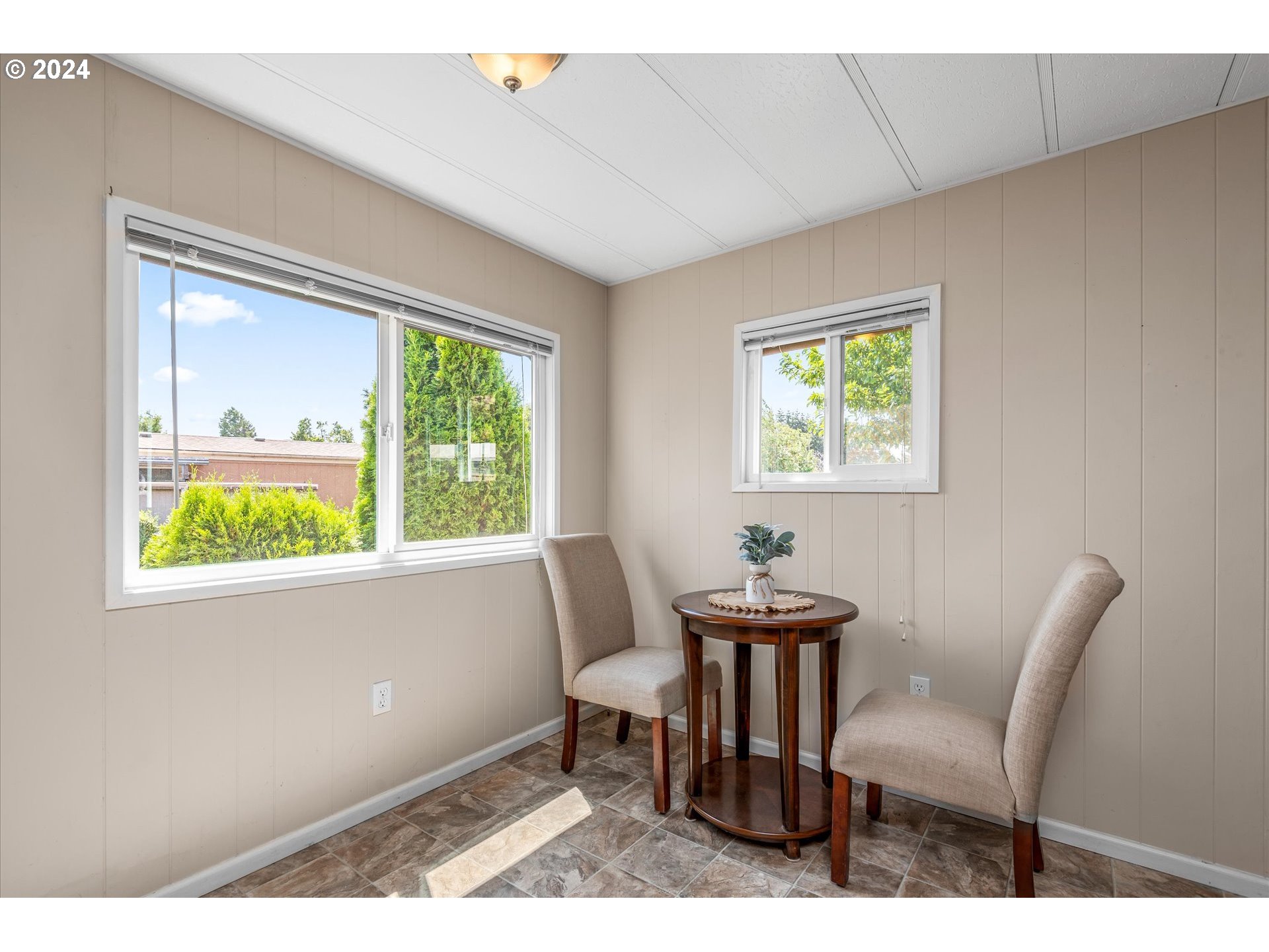 2150 Laura Street, Unit 90 Springfield, OR 97477 - Photo 7 of 18 a view of a dining room with furniture a rug and wooden floor