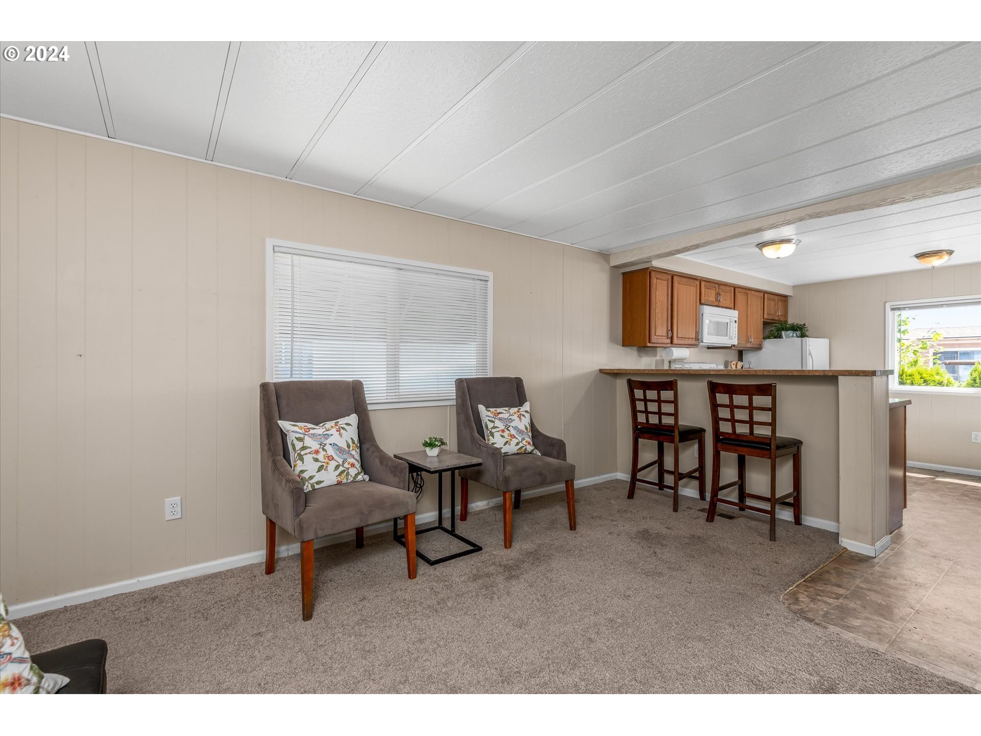 2150 Laura Street, Unit 90 Springfield, OR 97477 - Photo 9 of 18 a living room with furniture and a dining table