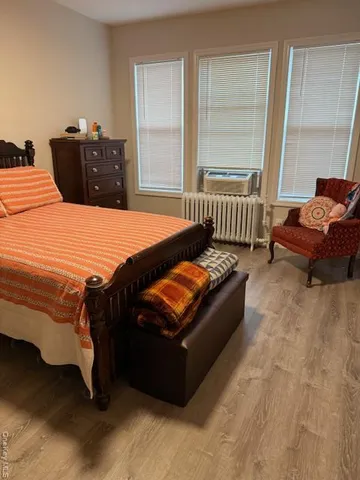 a bed sitting in a bedroom next to a window