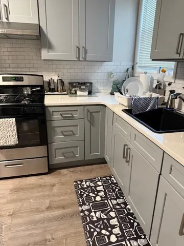 a kitchen with a sink and a stove