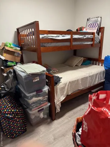 a bedroom with bed and a chandelier