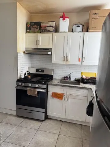 a kitchen with stainless steel appliances granite countertop a stove and a microwave