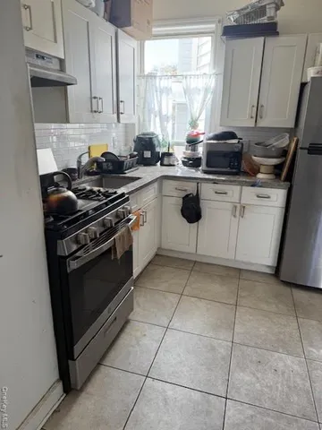 a kitchen with a stove sink and cabinets