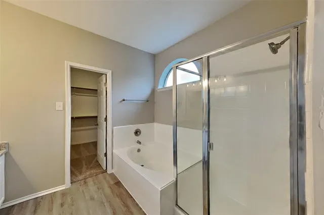 a bathroom with a bathtub and a shower
